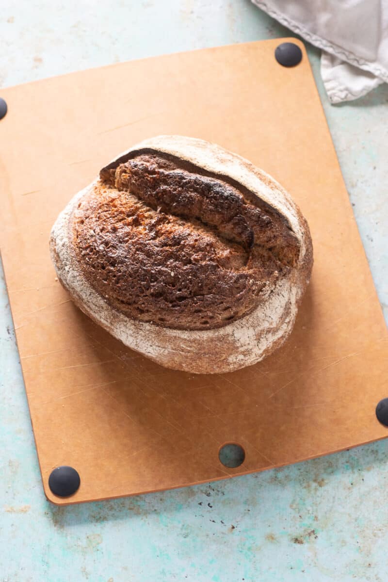 A rustic loaf of bread on a cutting board