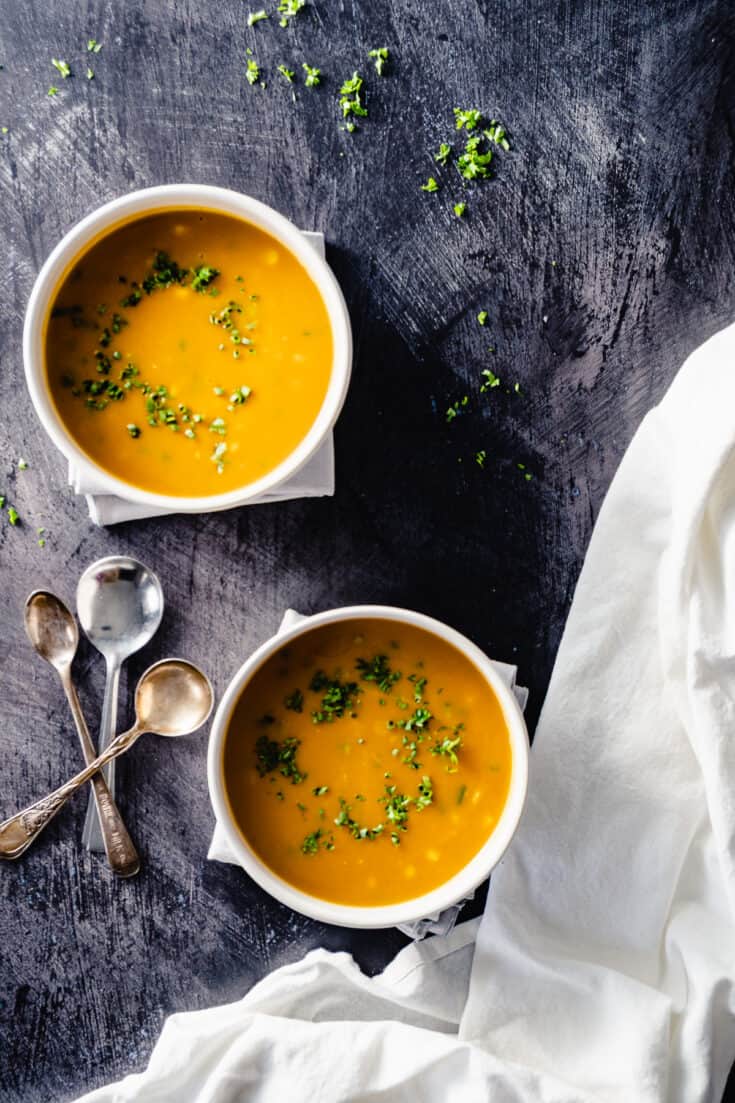 Corn, jalapeno, and sweet potato bisque in two bowls