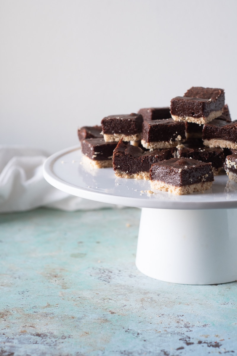 Almond Shortbread Brownies. Rich, fudgy bittersweet chocolate brownies baked on a crisp, buttery almond shortbread crust. Like handheld chocolate tarts. #brownies #chocolate #shortbread