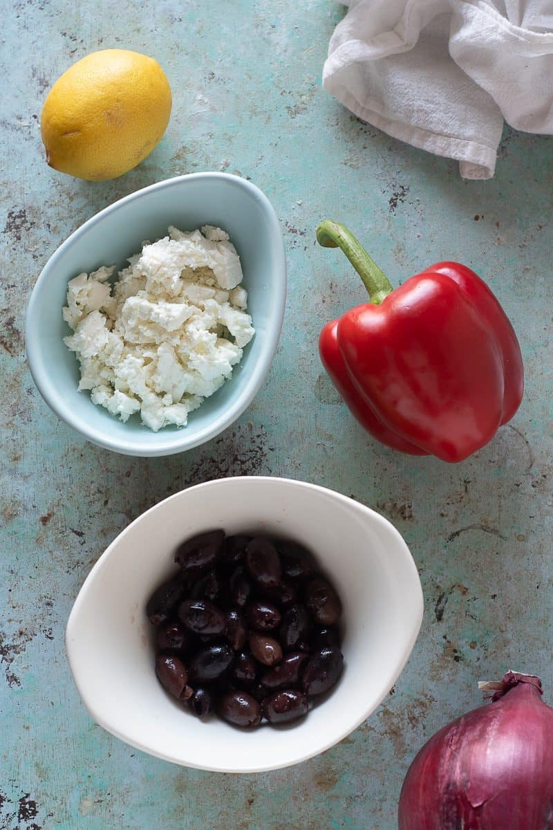 Lemon, crumbled feta, red bell pepper, black olives, red onion