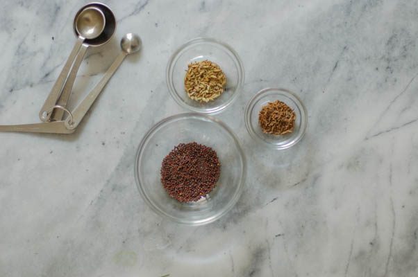 Cumin seeds, brown mustard seeds, measuring spoons