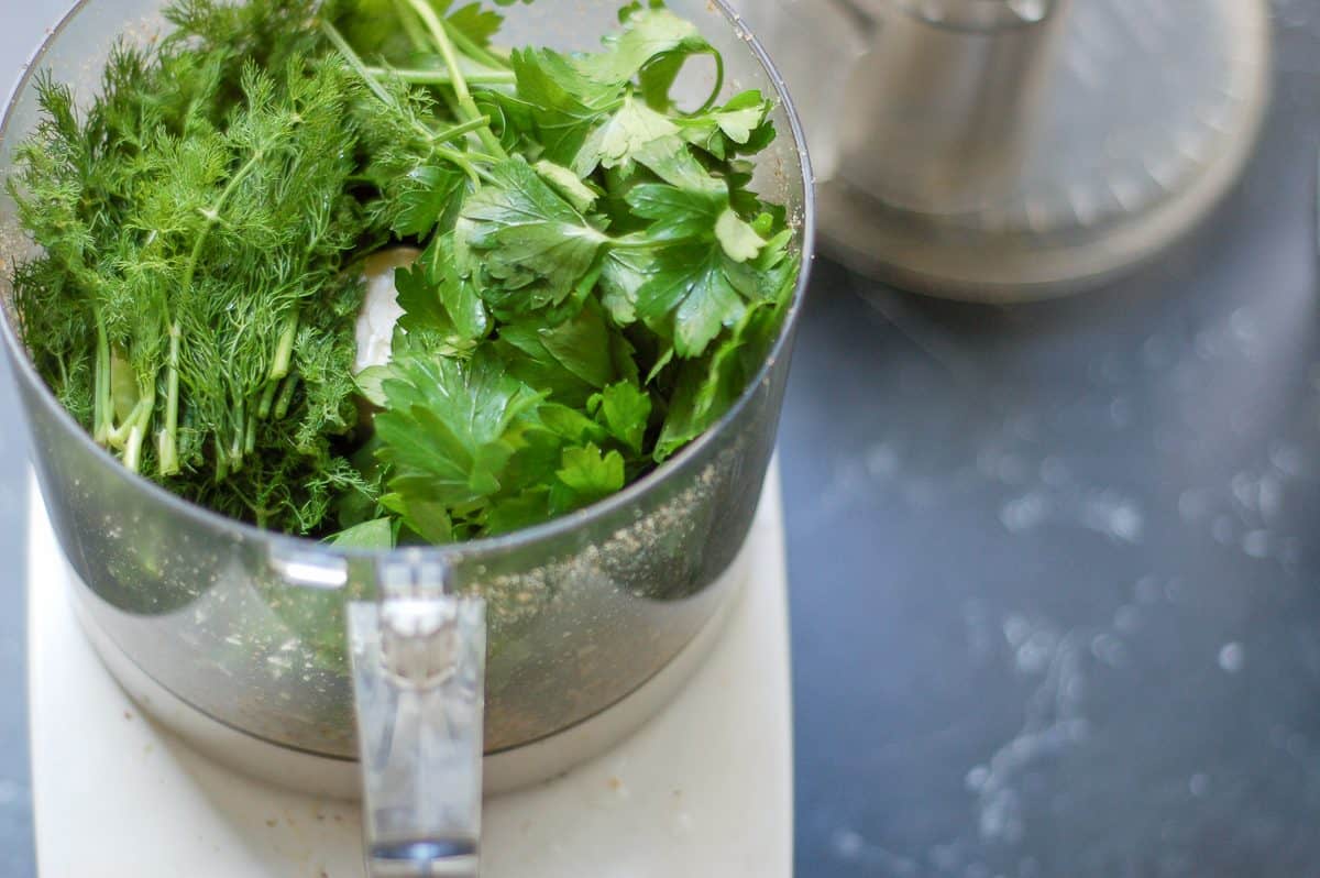 Fresh dill and parsley in a food processor