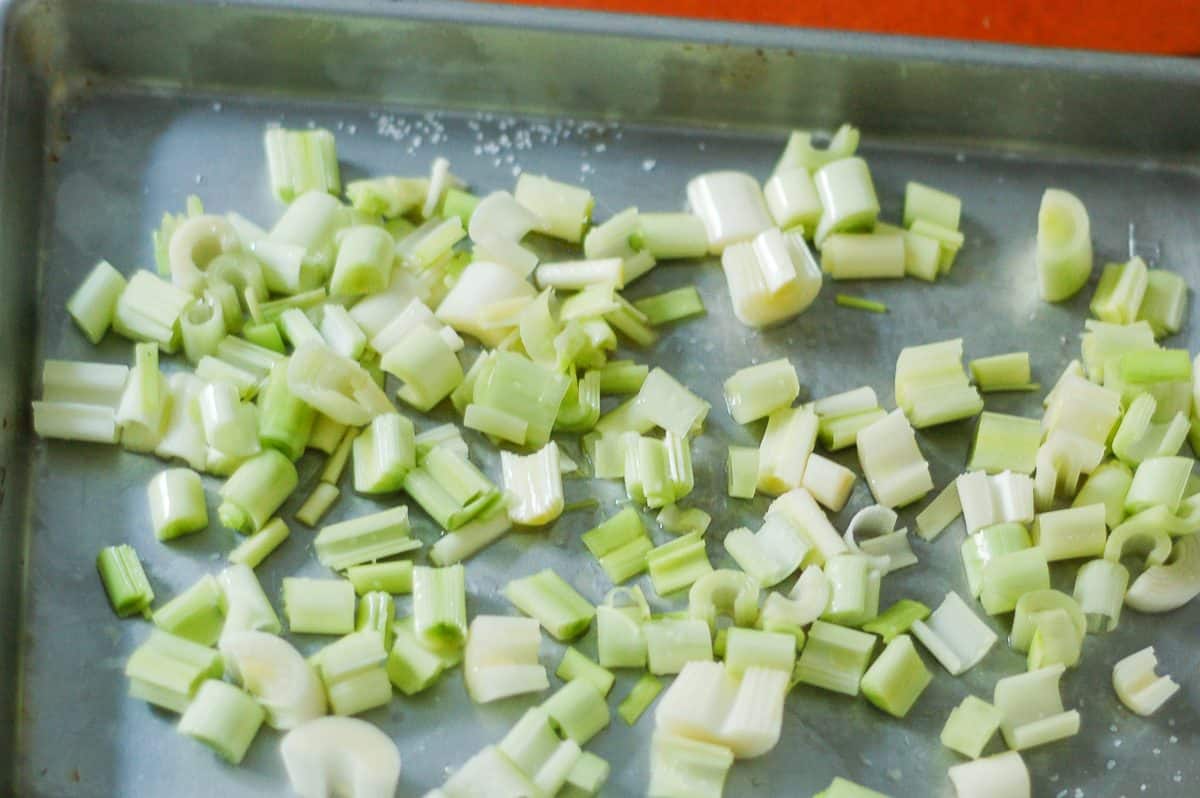 Sliced leeks on a roasting pan 