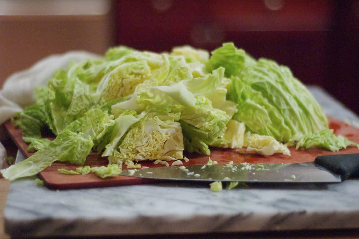 Thinly sliced savoy cabbage on a cutting board