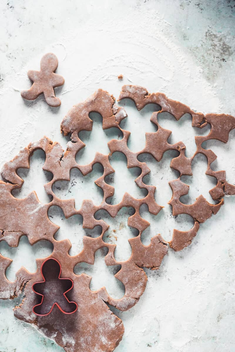 Gingerbread dough with gingerbread man shapes cut out