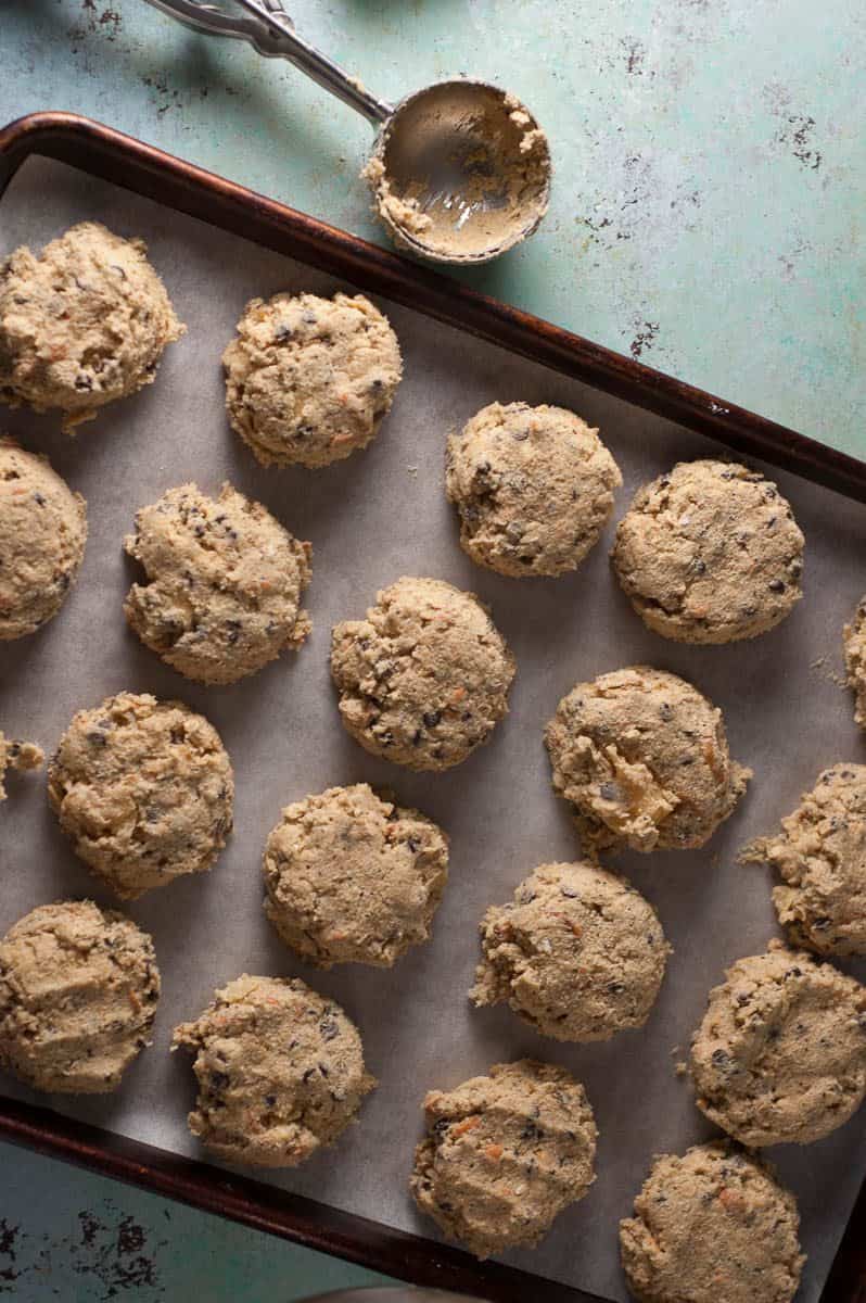 Unbaked compost cookies on a baking sheet