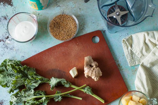 Pineapple Mango Ginger Green Smoothie. A bright green kale smoothie with tropical fruit, ginger, probiotics from kefir. A perfect way to start the day. From Blossom to Stem | Because Delicious | www.blossomtostem.net