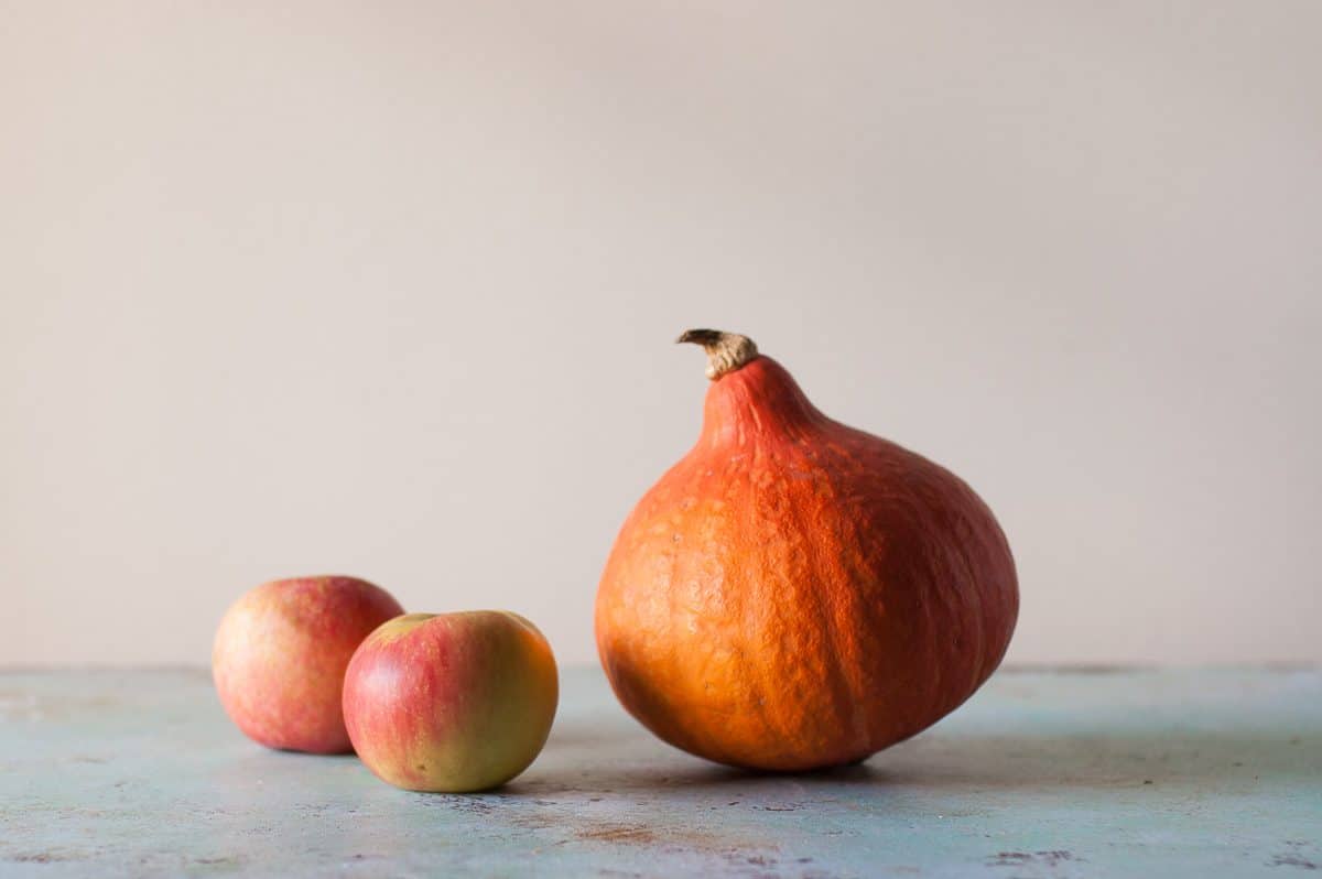 Two apples and a red kuri squash