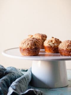 Cinnamon Sugar Oat Muffins on a white cake stand