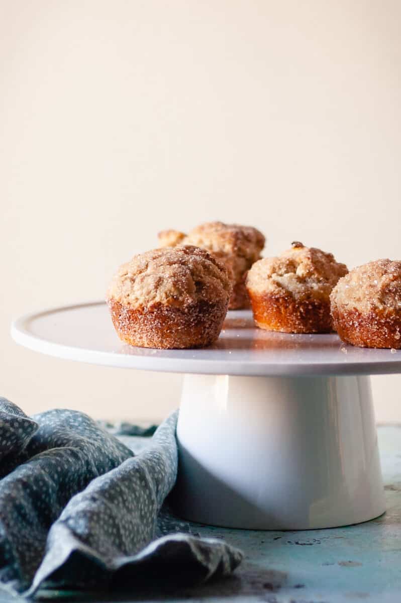 Cinnamon Sugar Oat Muffins on a white cake stand