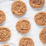 Chewy Citrus Molasses Spice Cookies on parchment paper