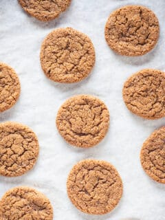 Chewy Citrus Molasses Spice Cookies on parchment paper