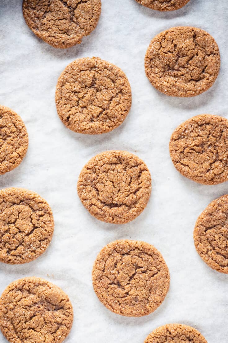 Chewy Citrus Molasses Spice Cookies on parchment paper