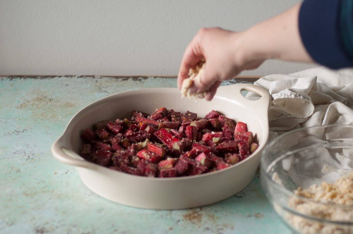 Sprinkling topping over rhubarb
