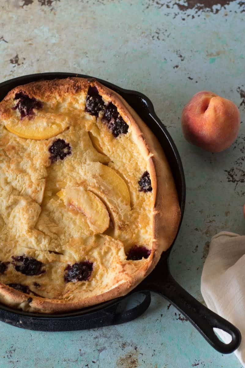 Blackberry Peach Dutch Baby. A puffy, golden oven pancake with berries and stone fruit. A simple sweet breakfast or brunch. From Blossom to Stem | Because Delicious | www.blossomtostem.net