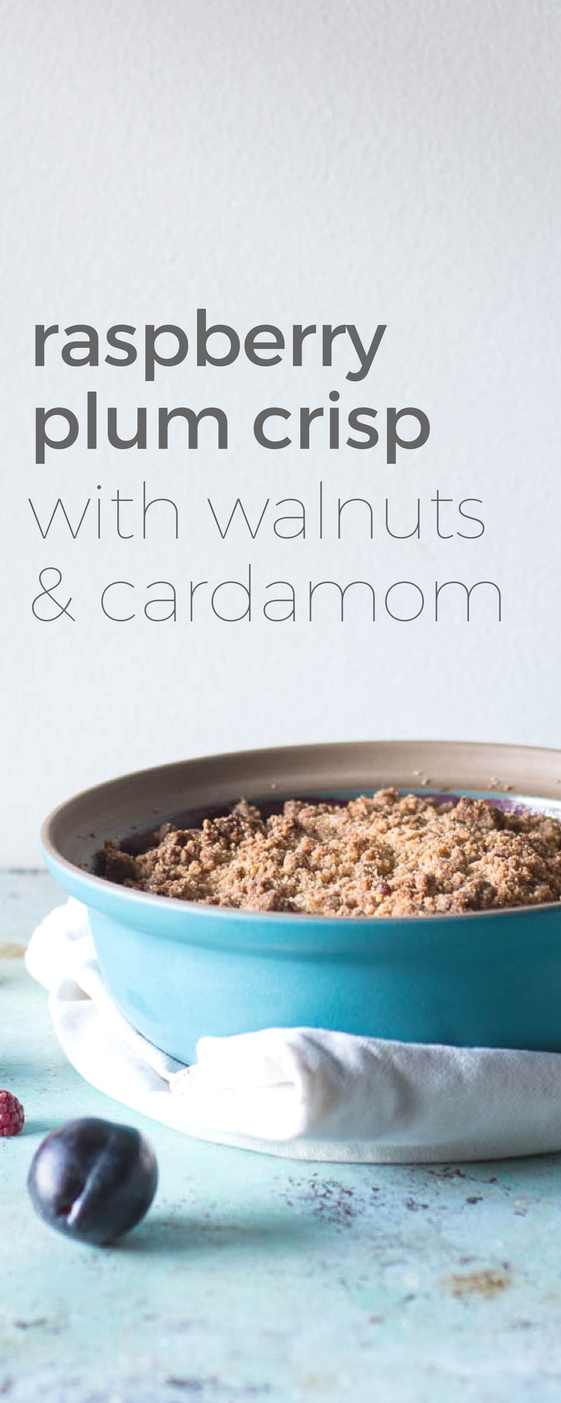 Raspberry Plum Crisp. A rustic dessert with baked raspberries and plums underneath a crumbly, walnutty, cardamom-scented topping.