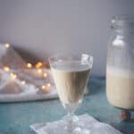 Small in a glass with twinkle lights in the background