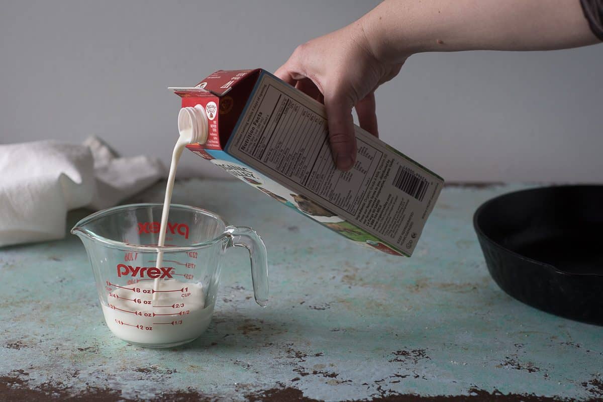 Pouring milk into a measuring cup