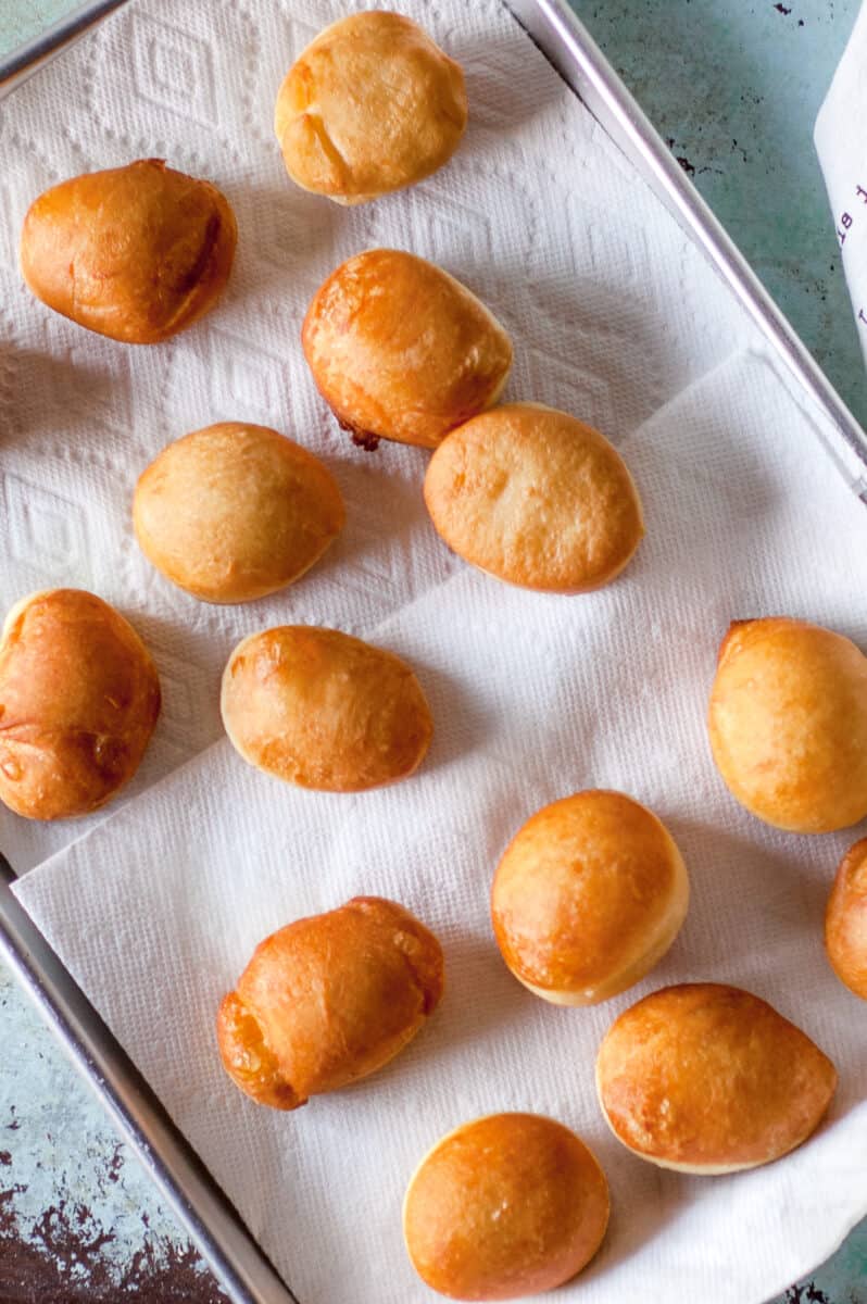 Freshly fried paczki on paper towels