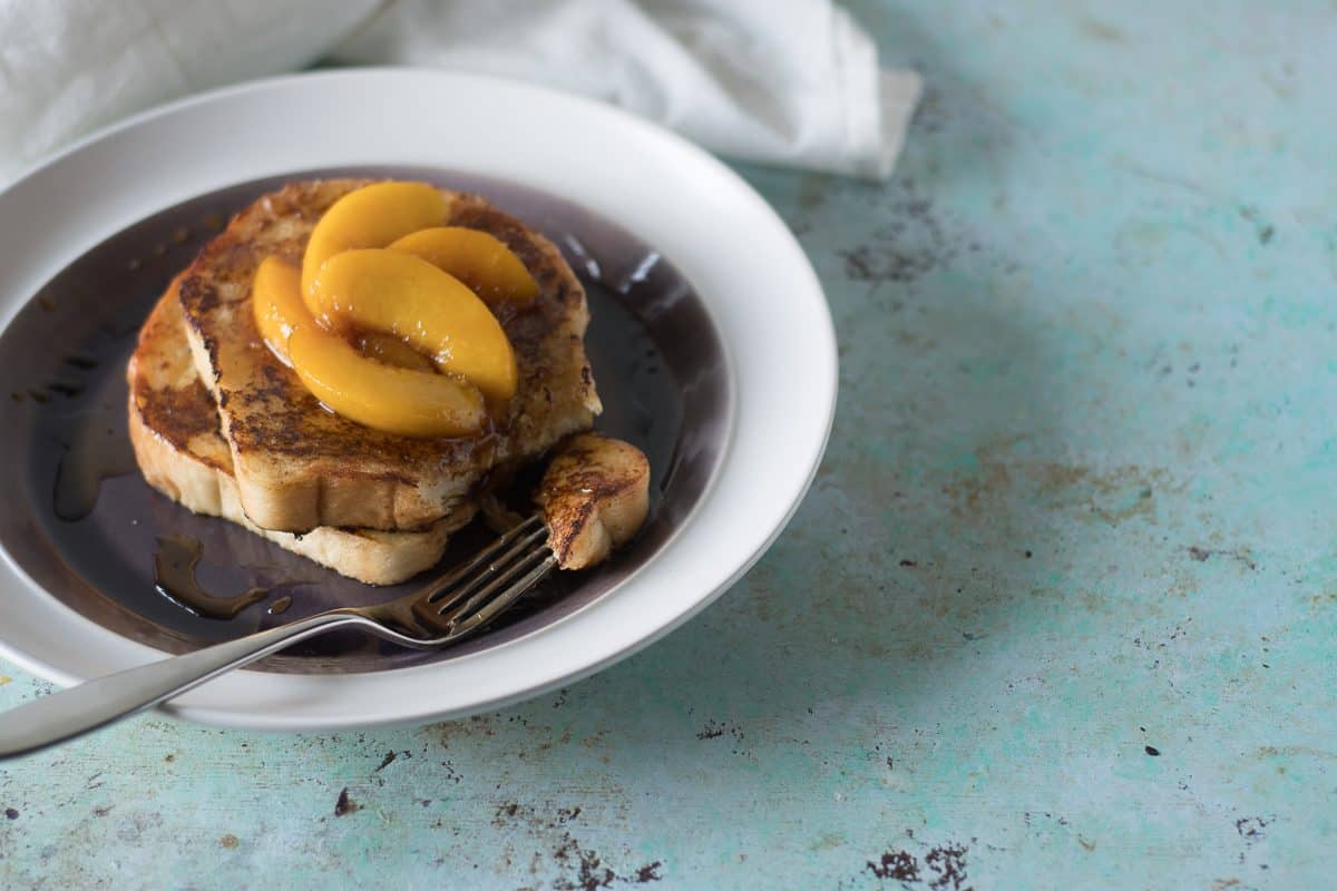 Buttermilk French toast topped with peaches