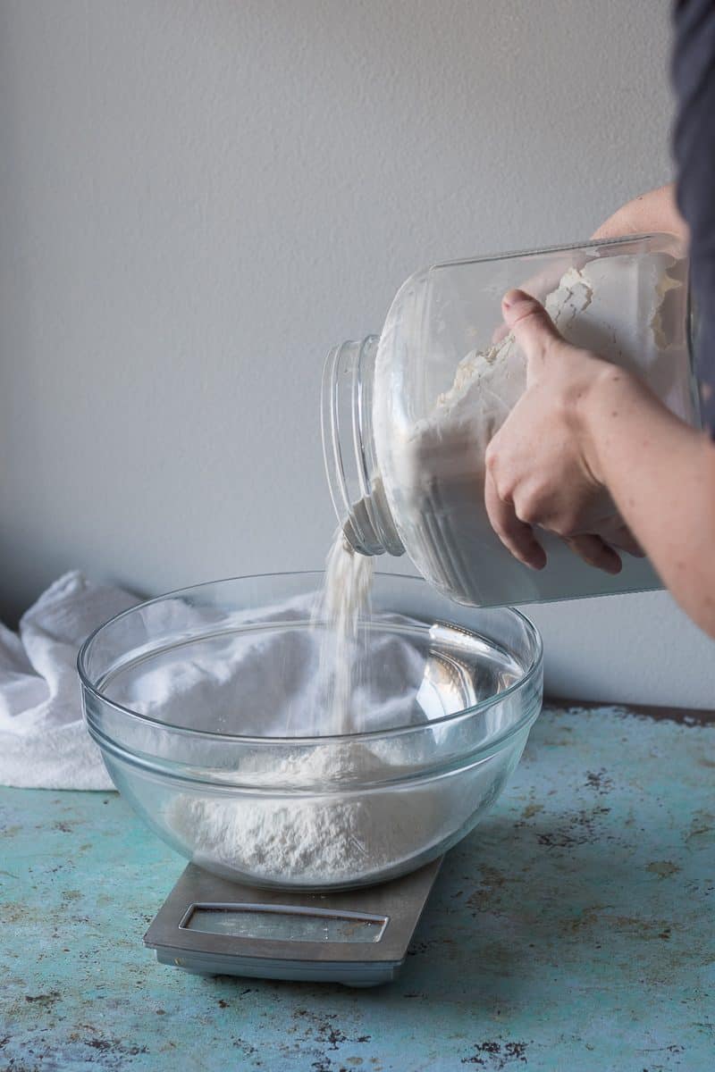 Adding flour to bowl on scal