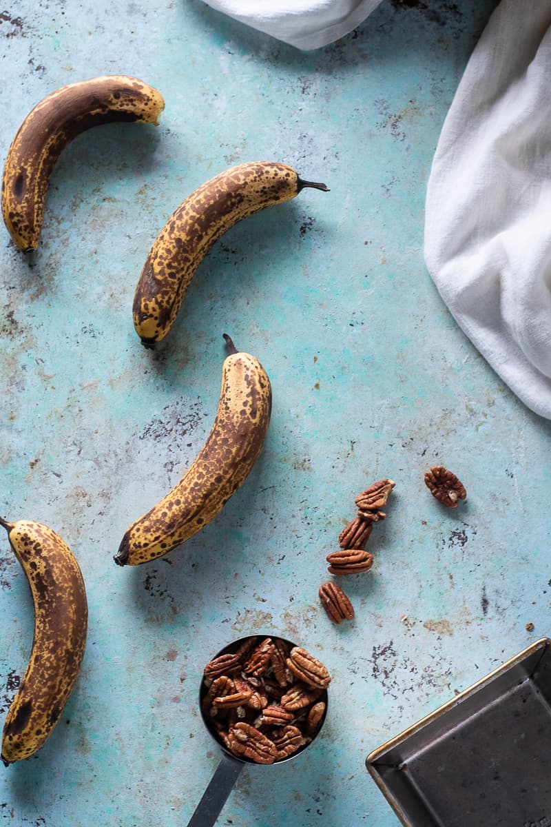 Browned bananas and pecans in a measuring cup