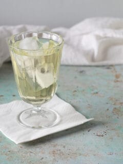 Clarified English Milk Punch in a glass over ice