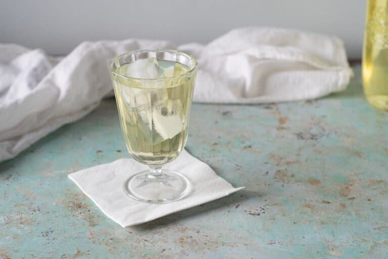 Clarified English Milk Punch in a glass over ice