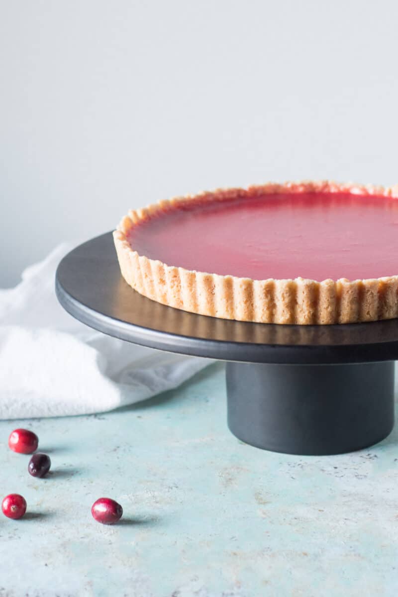 Cranberry Curd Tart on black cake stand