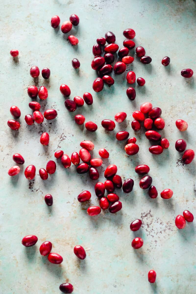 Cranberries scattered on a counter