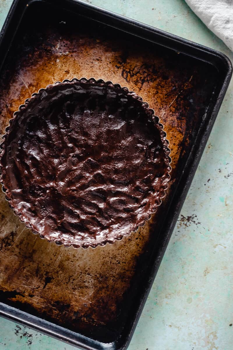 Chocolate tart crust, unbaked, on a sheet pan