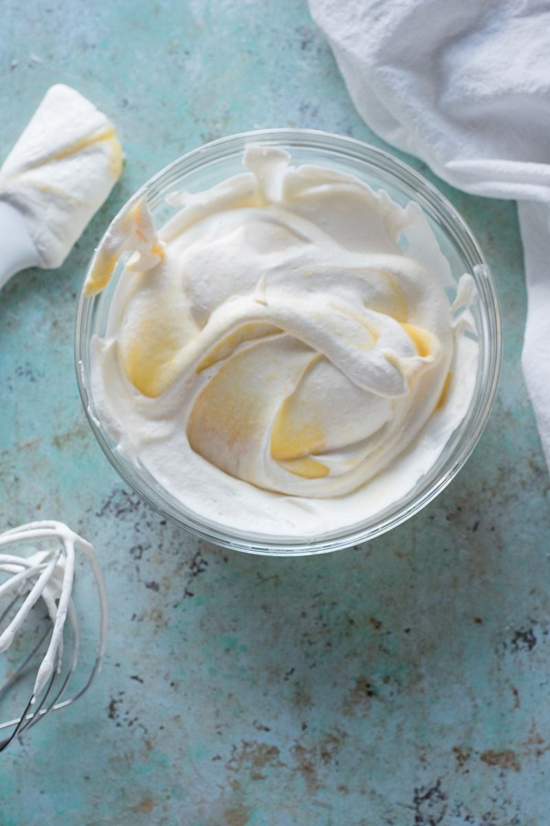 Partially folded meyer lemon ginger curd and whipped cream