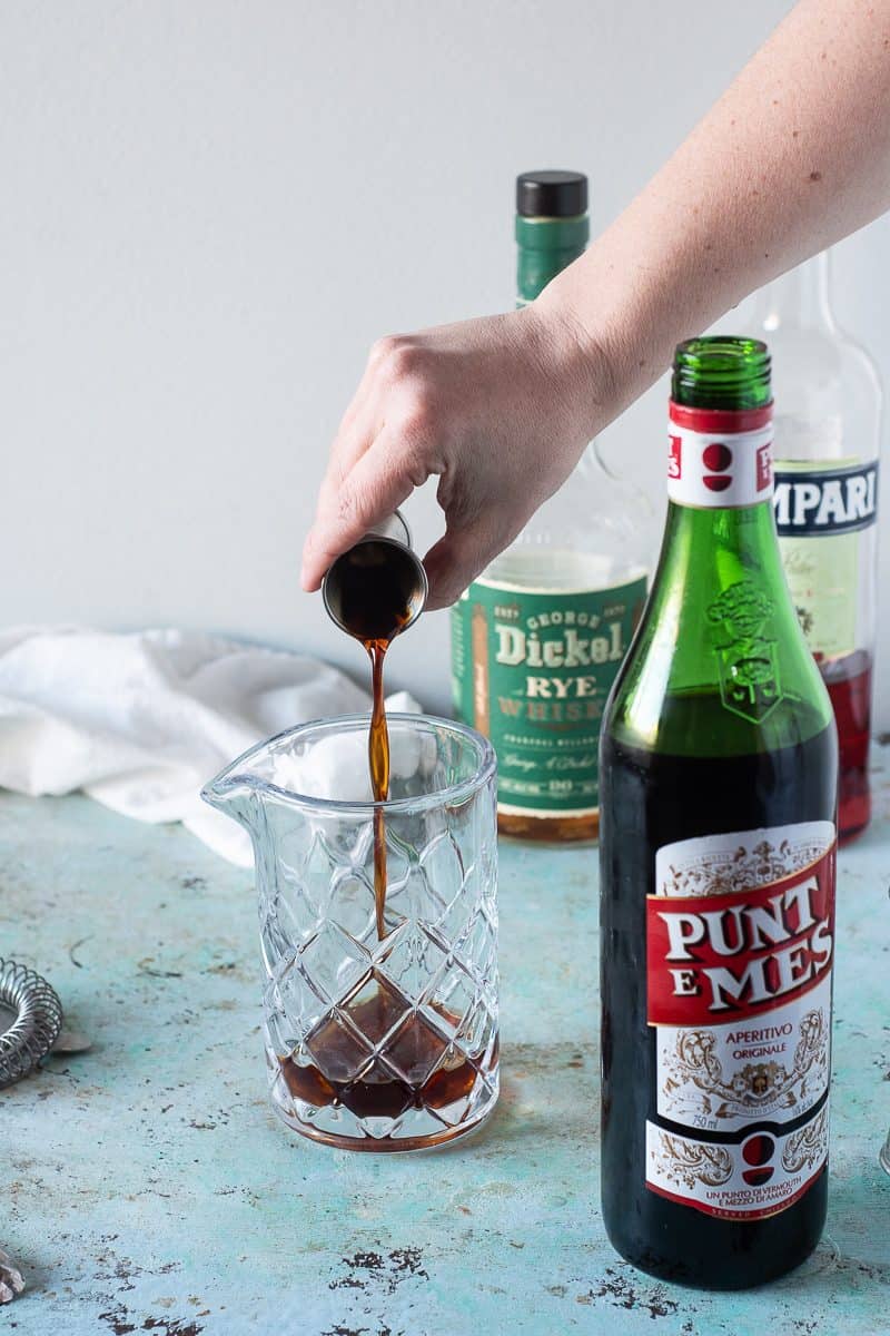 Pouring Punt e Mes into a mixing glass