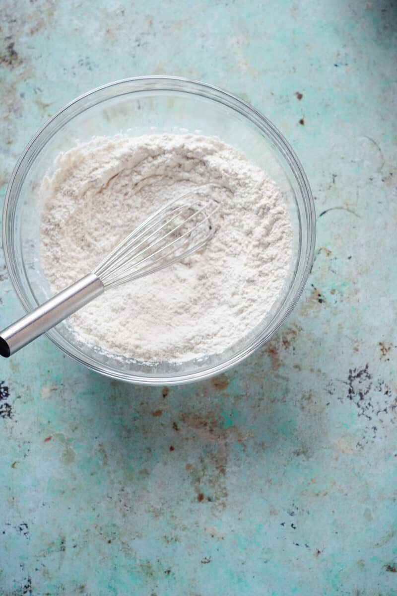 Flour in a mixing bowl with a whisk