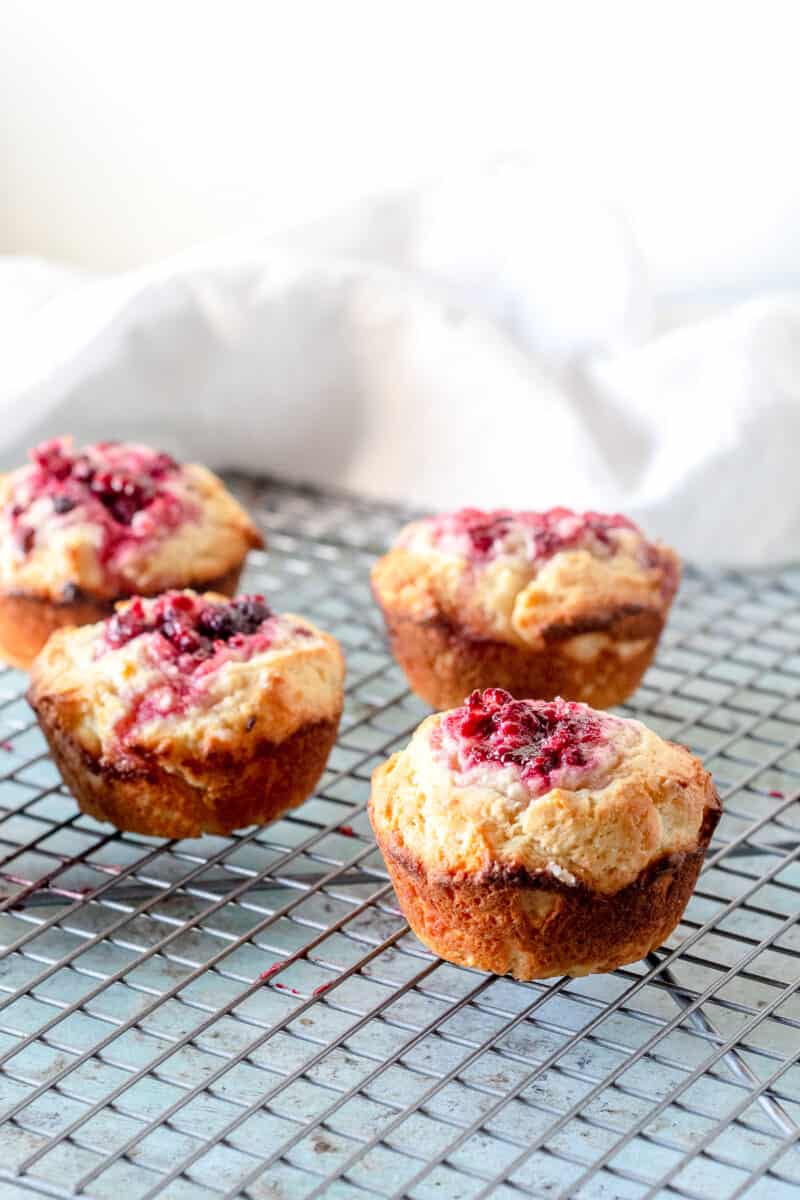 Raspberry lemon muffins on a cooling rack, side view