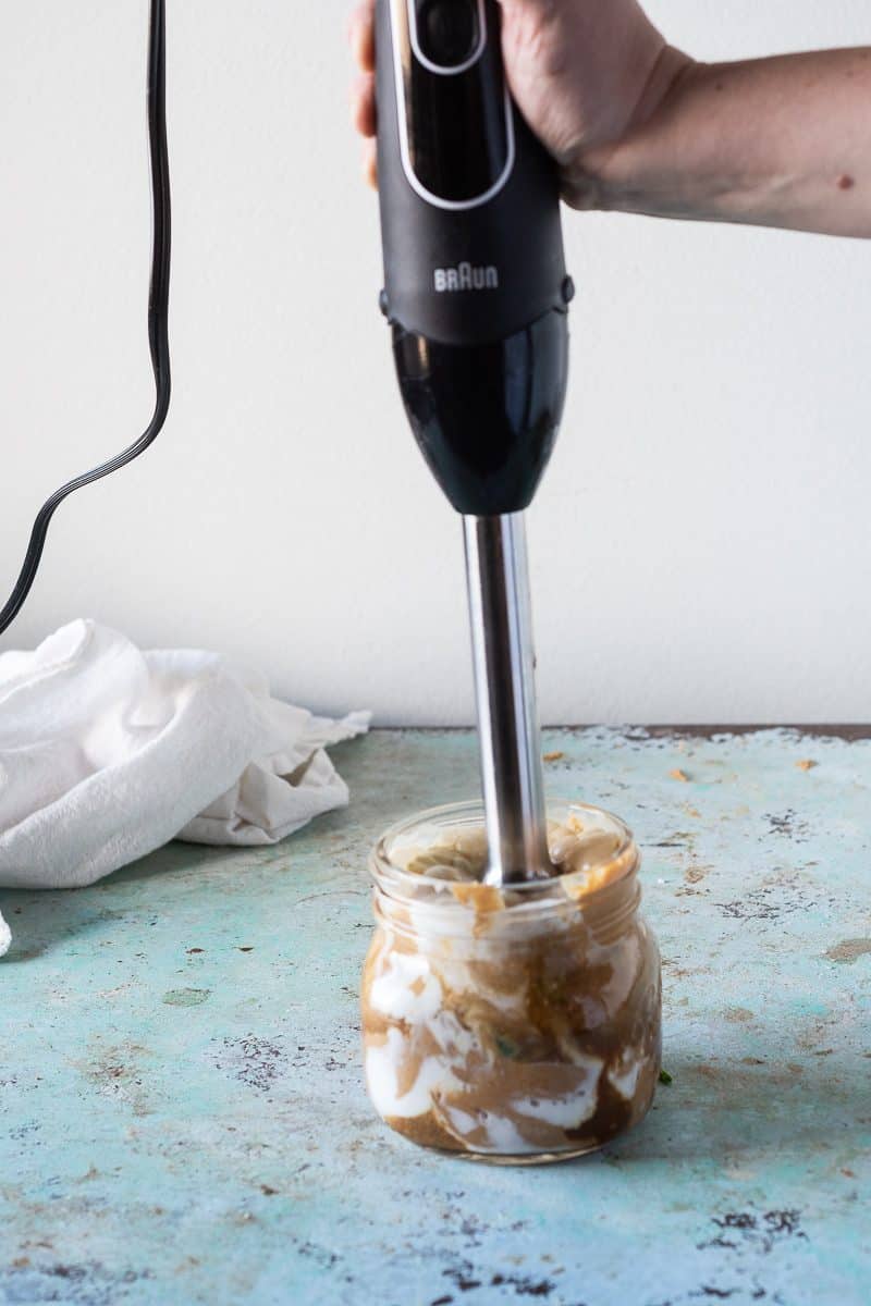 Blending peanut sauce with a stick blender