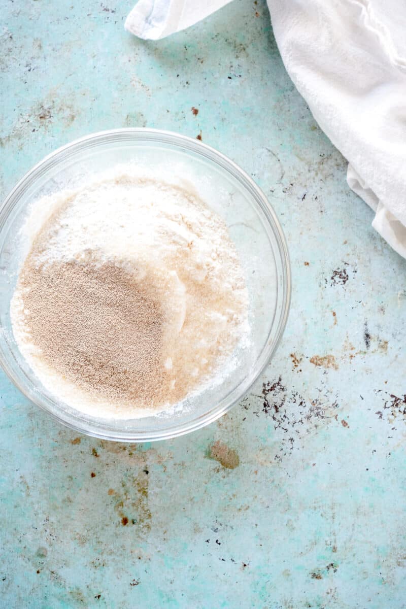 Flour and yeast and sugar in a mixing bowl