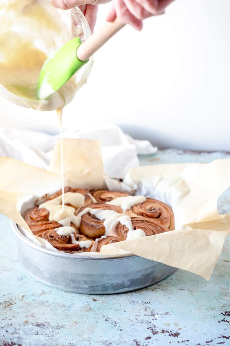 Drizzling icing over coffee cardamom morning buns