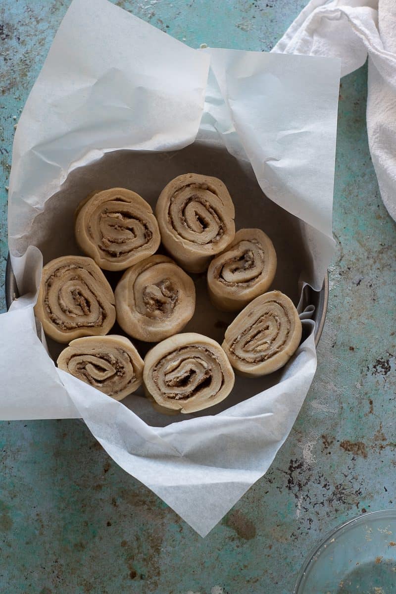 Sliced coffee cardamom morning buns in a pan before they go into the oven