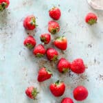 Strawberries strewn on a counter