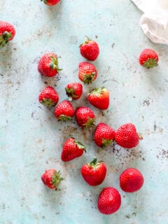 Strawberries strewn on a counter