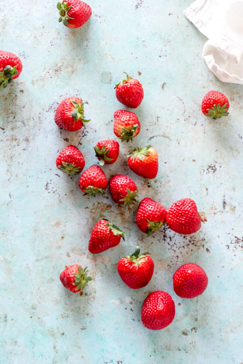 Strawberries strewn on a counter