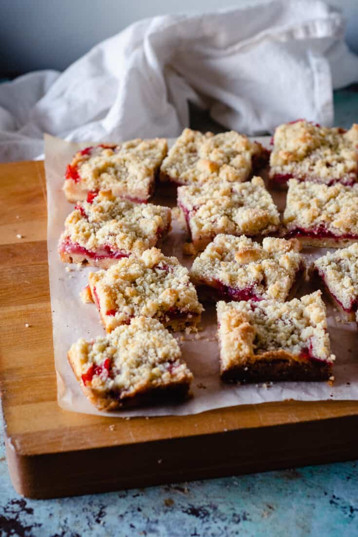 Strawberry Crumb Bars, sliced on a cutting board