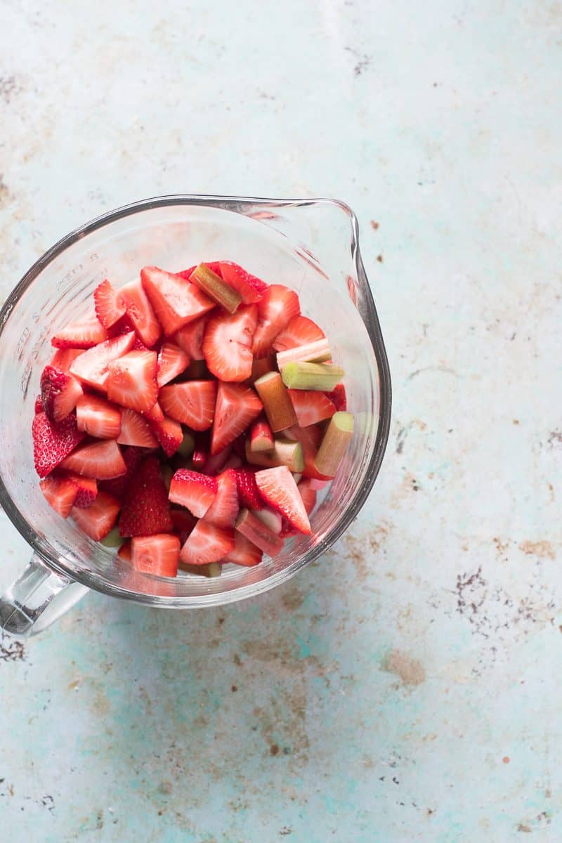 Sliced strawberries and rhubarb in a bowl