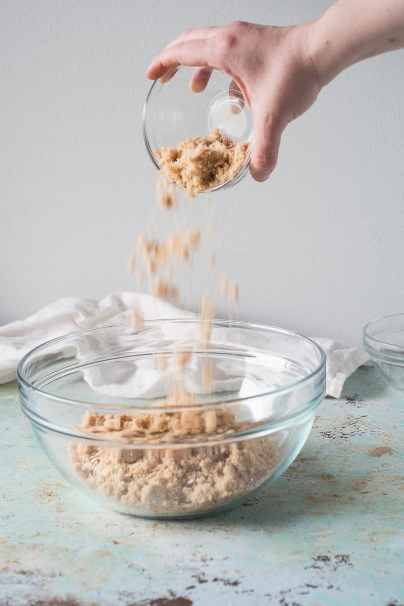 Brown sugar being sprinkled into a bowl