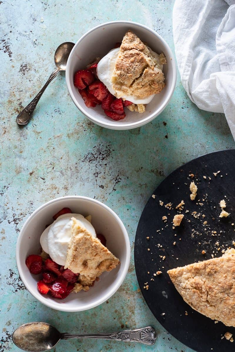 Strawberry shortcake sliced into wedges and served in bowls