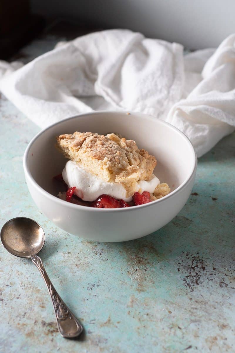 Strawberry shortcake in a bowl with a spoon
