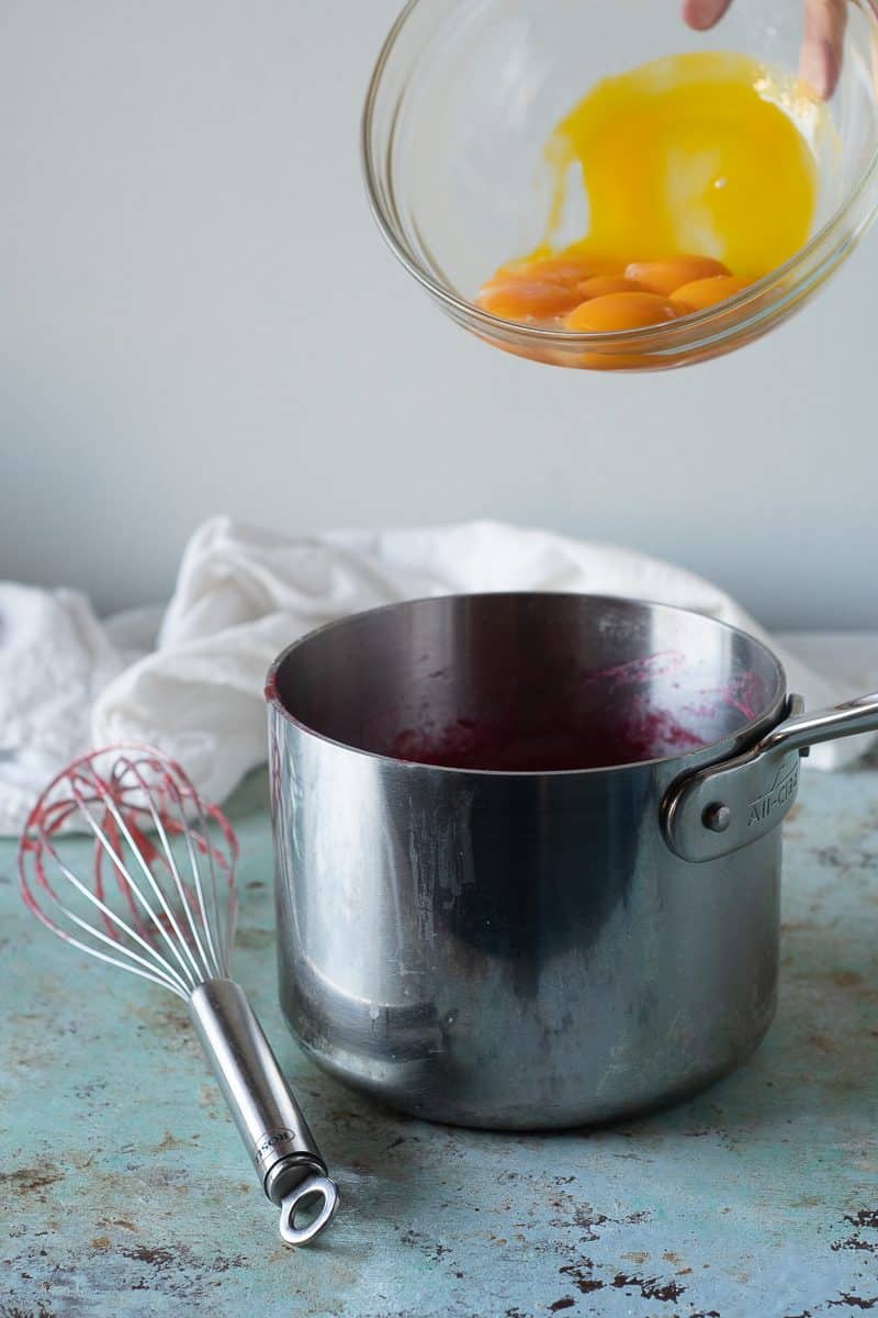 Adding egg yolks to rhubarb puree