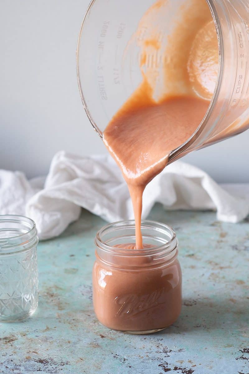 Pouring rhubarb curd into a jar