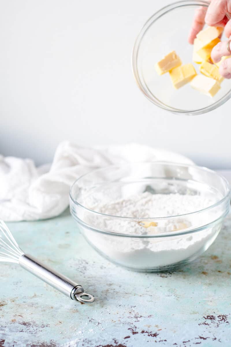 Adding cubes of butter to flour mixture